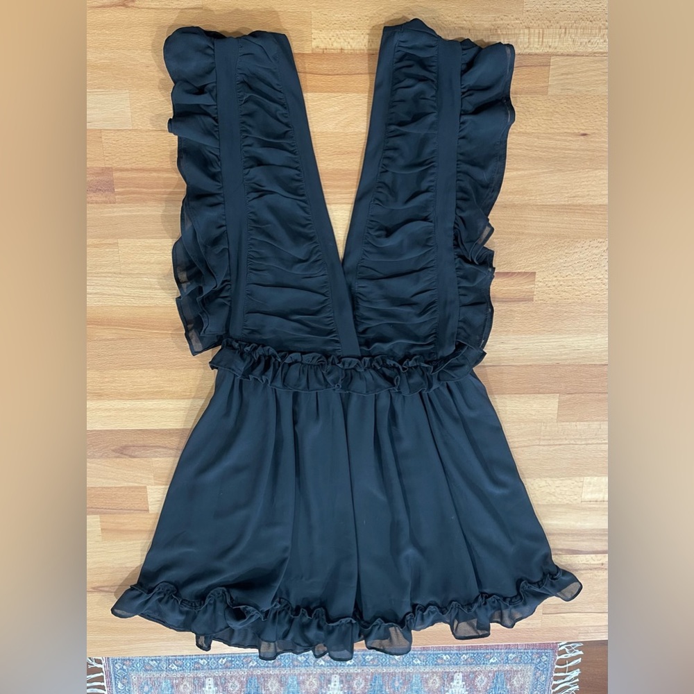 Perfect little black dress. Storia dress size small. Deep Vneck w/ ruffle detail